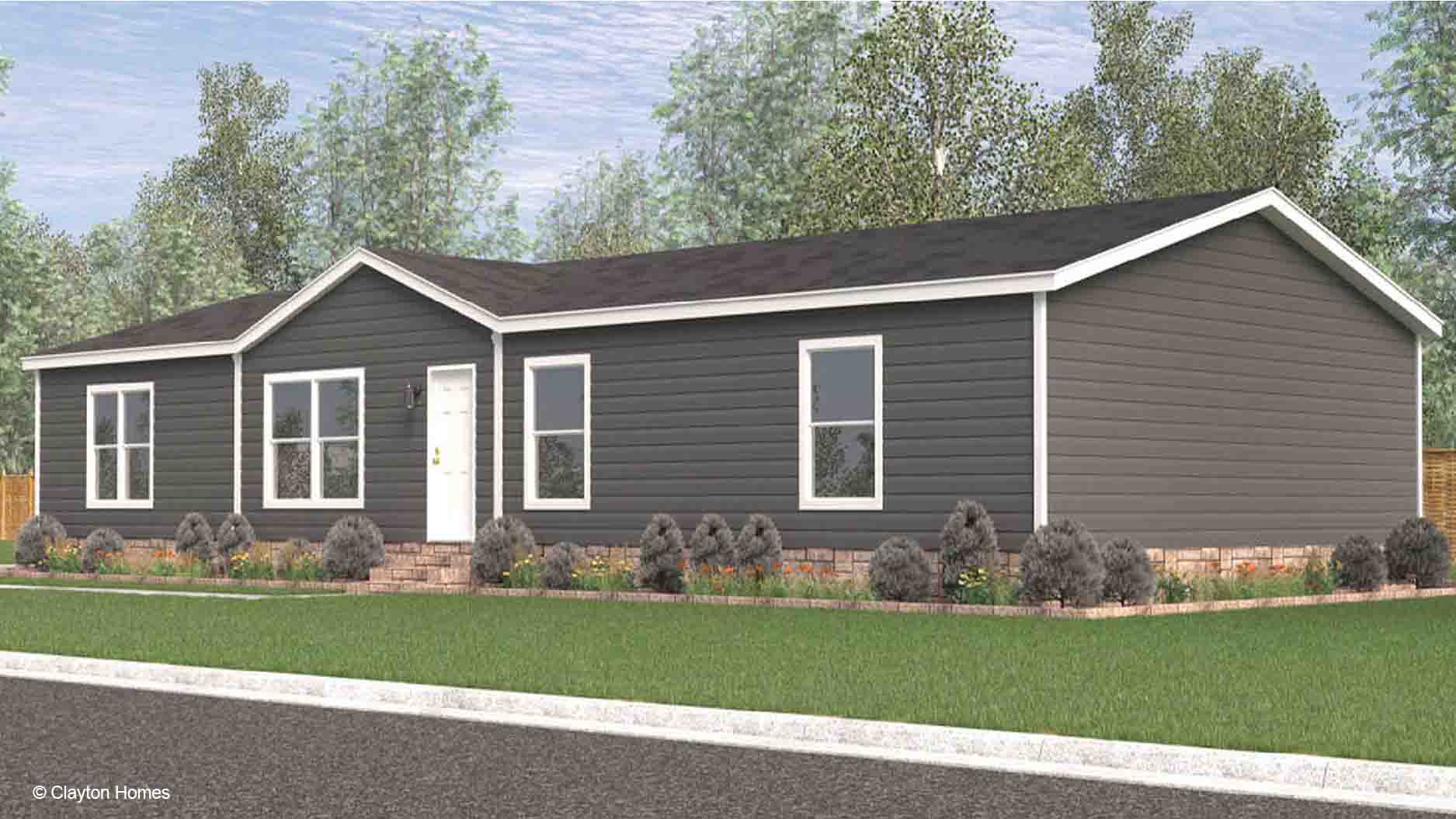 Single-story gray manufactured home with white trim, shrubs, and a green lawn in front offers comfortable living and charming curb appeal.