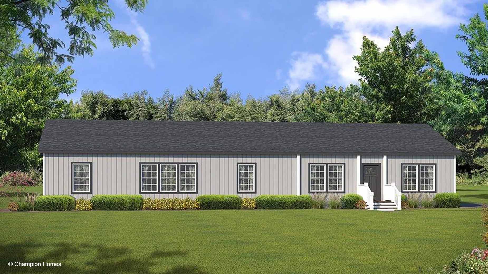 Single-story gray manufactured home with a black roof, white trim, and a front porch, set in a grassy yard with trees.
